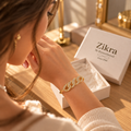 Woman wearing the Celeste gold cuff bracelet with sparkling interlocking links