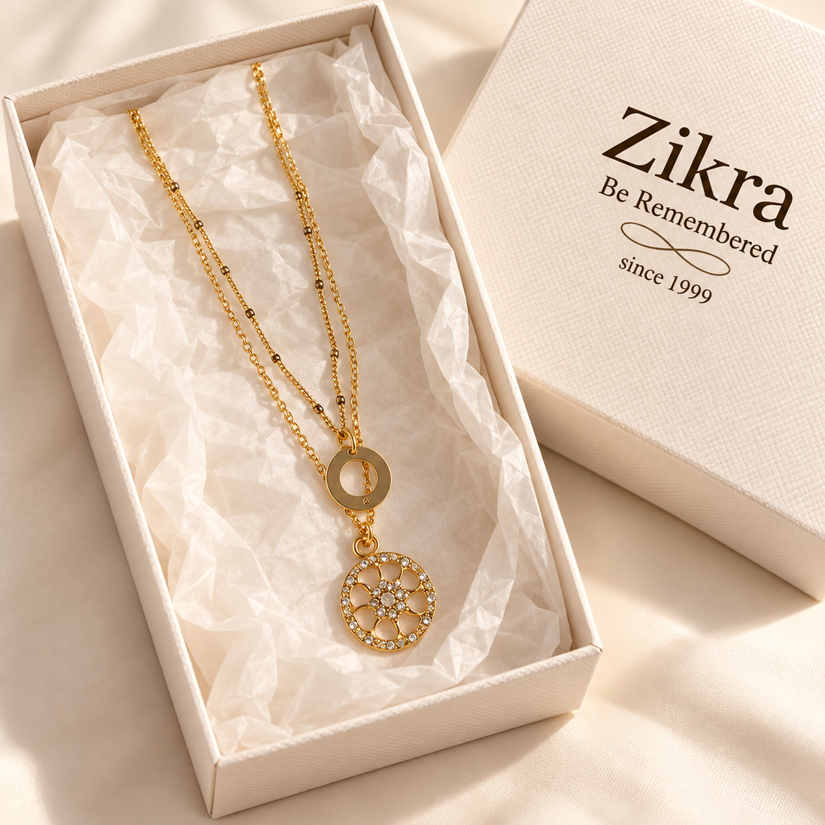 Elara layered gold necklace with sparkling medallion pendant in a Zikra gift box