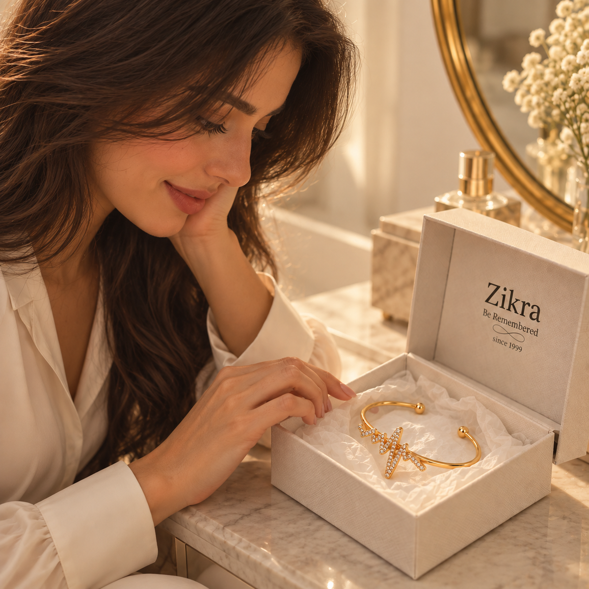 Woman opening a Zikra gift box with the Heartbeat gold bracelet