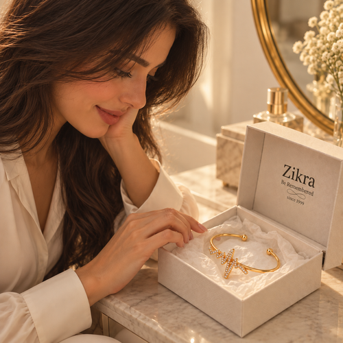 Woman opening a Zikra gift box with the Heartbeat gold bracelet